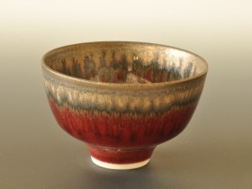 Tiny red and bronze bowl 9cm diameter.